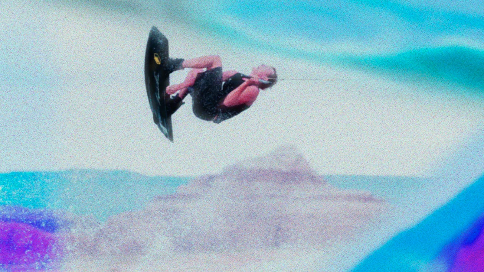 Liquid Force Wakeboard Rider Boosting High Above the Wake