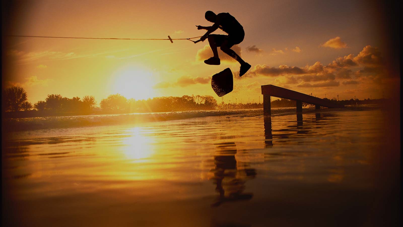 Wakeskate of the rail. Sunset session. Glassy Water. Wake Handle.