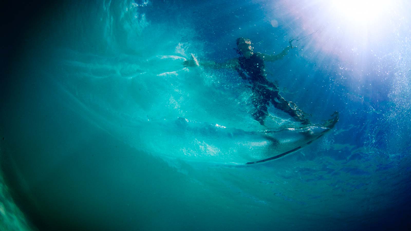 Underwater caption. Wakeboarder carving trough the torquoise water. Makes me want to go ride picture.