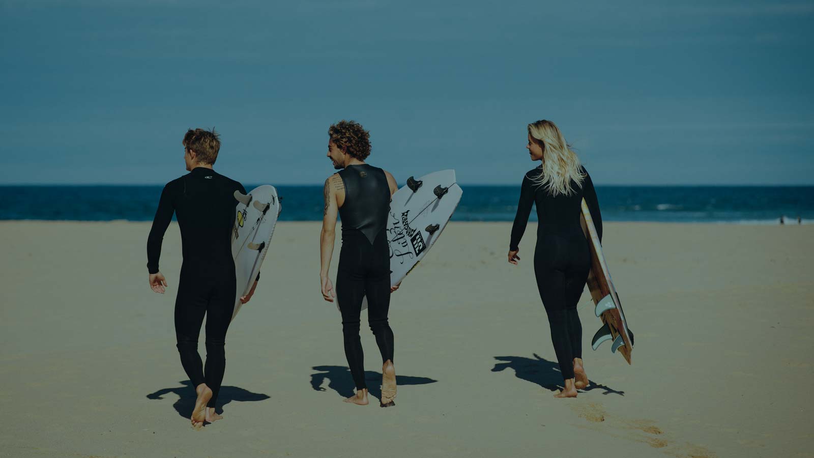 Beach. Group of people in Rental wetsuits. Whether you’re planning surfing, kiteboarding, SUP adventure, kayaking, or river ride, we offer well-maintained wetsuits ready for real Baltic conditions.